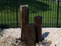 Rustic rock column water fountain surrounded by smooth stones, Walnut Bottom, Pennsylvania
